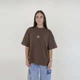 Remera color beige de corte holgado con logo de la marca Pulau bordado en el pecho.