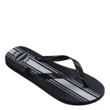 Sandalias Havaianas Essential de goma color negro con rayas blancas horizontales en la plantilla y tiras negras con textura.