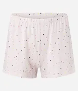 Pijama de dos piezas, compuesto por una remera blanca de manga corta con estampa de surf y un short rosa con lunares negros y cintura elástica.