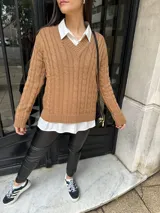 Sweater color marrón claro de tejido de punto con diseño de ochos y escote en V.