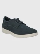 Zapato acordonado de cuero azul marino con suela blanca de goma.