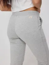 Pantalón deportivo tipo jogging color negro, confeccionado en 60% algodón y 40% poliéster, con cintura elástica ajustable con cordón, bolsillos laterales y puños ajustados con cierre en los tobillos.