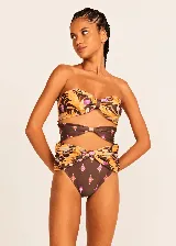 Conjunto de bikini Triya con estampado floral en tonos marrones, naranjas y violetas. El corpiño es strapless con nudo central y la bombacha es de tiro alto con aberturas laterales.