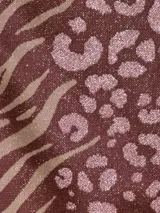 Conjunto de bikini marrón con estampado animal print, compuesto por un corpiño triangular con tiras finas y una bombacha con tiras laterales ajustables.