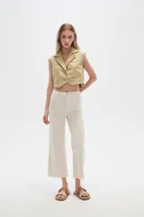 Chaleco cropped de jean color verde claro, con solapas y cierre frontal con botones.