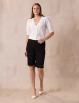 Bermuda color beige en gabardina elastizada, con pretina ancha elastizada, bolsillos simulados en la parte delantera y bolsillos aplicados en la parte trasera.