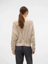 Sweater de punto calado color crema, con cuello redondo y mangas largas.