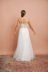 Vestido largo de microtul blanco con brillo y apliques de flores, con breteles finos y falda con vuelo. Ideal para quinceañeras.