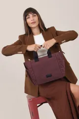 Cartera negra tipo tote bag con diseño capitoneado, doble asa corta y correa larga ajustable. Incluye bolsillos laterales y bolsillo frontal amplio.