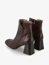 Botín de cuero color marrón oscuro con tacón cuadrado y cierre lateral.