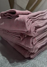 Pantalón de jersey térmico a rayas verticales color bordó y rosa, con elástico en la cintura.