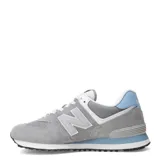 Championes urbanos New Balance modelo 574, color gris con detalles en celeste y blanco, confeccionados en gamuza y malla, con logo "N" característico en los laterales y entresuela ENCAP.