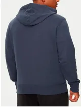 Buzo con capucha Calvin Klein color azul petróleo, con bolsillo tipo canguro, cordones ajustables y logo de la marca en la manga. Confeccionado en felpa de algodón.