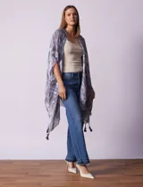 Kimono tejido con estampado abstracto en tonos grises y blancos, con mangas cortas y terminación de ruedo con borlas negras.