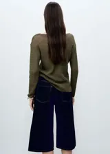 Sweater de punto calado color crudo, con escote barco y mangas largas.