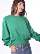 Buzo verde de algodón con cuello redondo y mangas largas abullonadas.