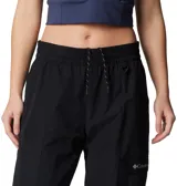 Pantalón negro de mujer, de corte recto y tiro alto, con cintura elástica ajustable con cordón, bolsillos laterales y bolsillo adicional en la pierna. Cuenta con puños ajustables con cordón y forro de malla para mayor transpirabilidad.