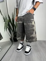 Bermuda gris oscuro con efecto lavado, corte ancho, bolsillos laterales y traseros con detalle de costuras reforzadas.