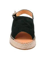 Sandalias negras de cuero con plataforma de yute y tira trasera con hebilla. Diseño basado en tendencias españolas.