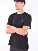 Remera negra de corte clásico con textura tipo waffle y logo pequeño en el pecho.