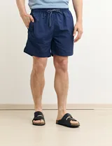 Short de baño azul con cintura elástica y cordón ajustable.