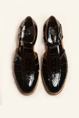 Sandalia marrón de cuero vacuno con diseño de tiras entrecruzadas, hebilla lateral y taco bajo de 2,5 cm.