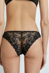 Bombacha vedetina blanca de encaje floral con moño pequeño en el frente.