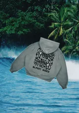 Hoodie gris con estampado de palmeras y texto 'Glassy Waves' en la espalda.