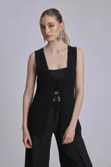 Chaleco negro de punto con cuello redondo y sin mangas.