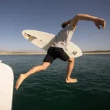 Remera de manga corta color gris claro con finas rayas horizontales negras.