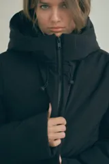 Anorak negro resistente al agua y al viento con aislamiento térmico, cuello alto con capucha ajustable, mangas largas con puño interior de neopreno, tirantes elásticos interiores, bolsillos delanteros con forro polar y cierre de cremallera, bolsillo interior con cremallera oculta y cierre frontal con cremallera termosellada.