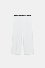 Pantalón culotte blanco de tiro medio confeccionado en hilatura con viscosa, con cinturón ajustable con hebilla metálica y pierna ancha. Cierre lateral con cremallera oculta en costura.