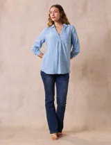 Blusa celeste de lyocell, con cuello con solapa, escote en V y abertura con botones. Mangas ¾ con puño y botón.