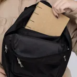 Mochila negra con logo Converse Chuck Taylor en blanco. Cuenta con un bolsillo frontal con cierre, correas ajustables y espalda acolchada.