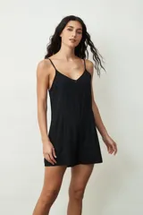 Mono corto color crudo, con breteles finos, escote en V y cierre frontal con botones.