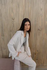 Blazer verde con rayas verticales blancas, solapas clásicas y corte entallado.