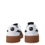 Championes Puma Carina 3.0 de cuero blanco con detalles en lila, suela de plataforma y logo dorado.