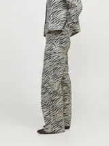 Pantalón de pierna ancha con estampado de cebra, tiro alto, cierre con cremallera y múltiples bolsillos.