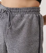Short corto gris con textura de hilo metalizado, cintura elástica con cordón ajustable y detalles laterales en negro.