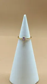 Anillo dorado ajustable con una piedra rectangular de amatista.