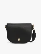 Cartera saddle negra de Tommy Hilfiger con correa de textil trenzado ajustable y extraíble, cierre de solapa magnético, bolsillo interior con cremallera e insignia del monograma TH en la parte delantera.