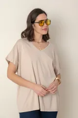Remera holgada color beige, de escote en V y mangas cortas.