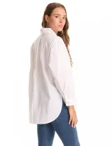 Camisa oversize blanca de tencel, con cuello con solapa, botones frontales, mangas largas con hombros caídos y puños anchos. Incluye un bolsillo en la parte delantera y un tablón central en la espalda. El bajo es redondeado y asimétrico, más largo en la espalda.
