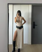 Falda larga dorada con abertura lateral alta.