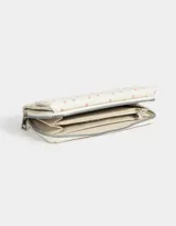 Billetera de cuerina estampada con cierre circundante y puller de material principal. Solapa con broche con botón para cerrado.