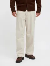 Pantalón de jean color beige, de corte amplio y tiro alto. Diseño clásico de cinco bolsillos y cierre con botones.