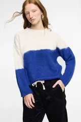 Sweater tejido en jersey con diseño en dos colores: blanco en la parte superior y azul en la parte inferior.