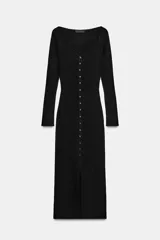 Vestido midi negro de tejido de punto acanalado, manga larga y escote corazón. Presenta una hilera de botones decorativos en el frente y una abertura en el bajo.