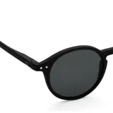 Lentes de sol Izipizi modelo #D, color negro, con montura redonda y patillas flexibles.