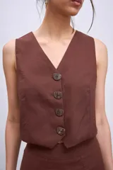 Chaleco marrón con escote en V y cierre frontal con botones.